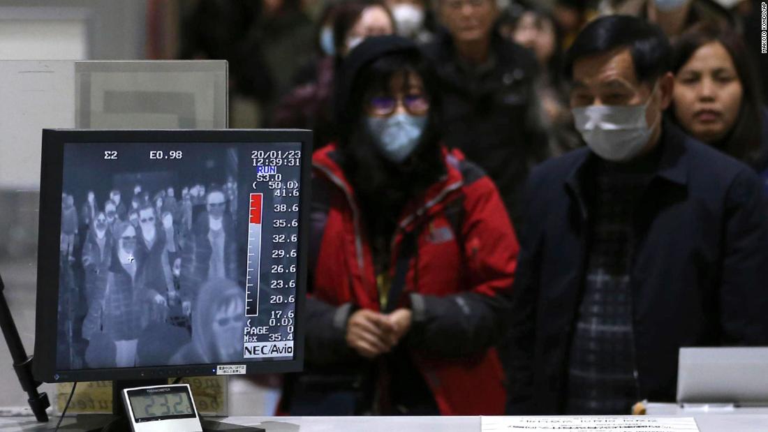 Passengers are checked by a thermography device at an airport in Osaka, Japan, on January 23.